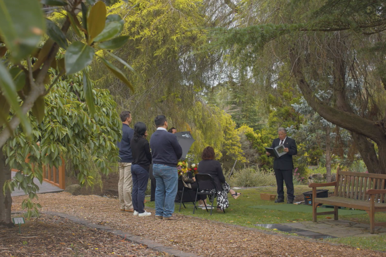 Family and friends mark the interment of a loved one's ashes at an honouring life service