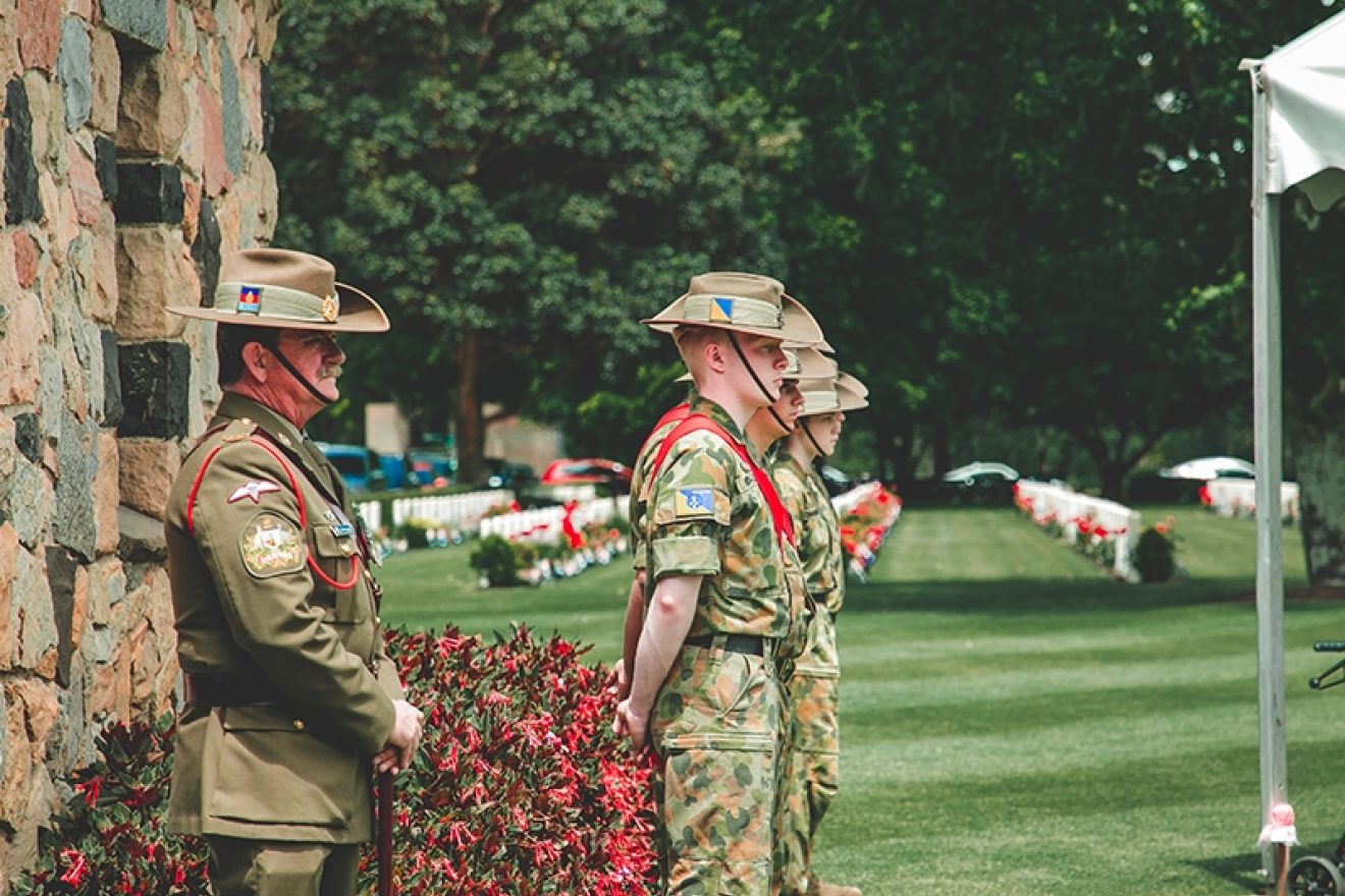 A photograph of soldiers in Australian military uniforms at the Australian War Graves, Springvale Botanical Cemetery