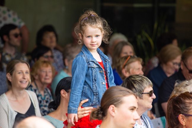 Girl on parents shoulders at SMCT event