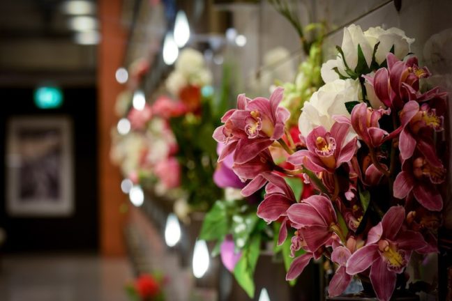 Floral arrangements adorn the walls of a mausoleum at Springvale Botanical Cemetery in remembrance of loved ones
