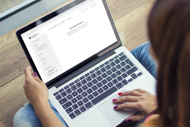 A woman uses the SMCT Deceased Search online tool on her laptop computer