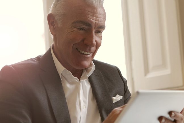 Father looking at live funeral streaming