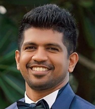 A headshot of SMCT IT Consultant, Charlie Perera