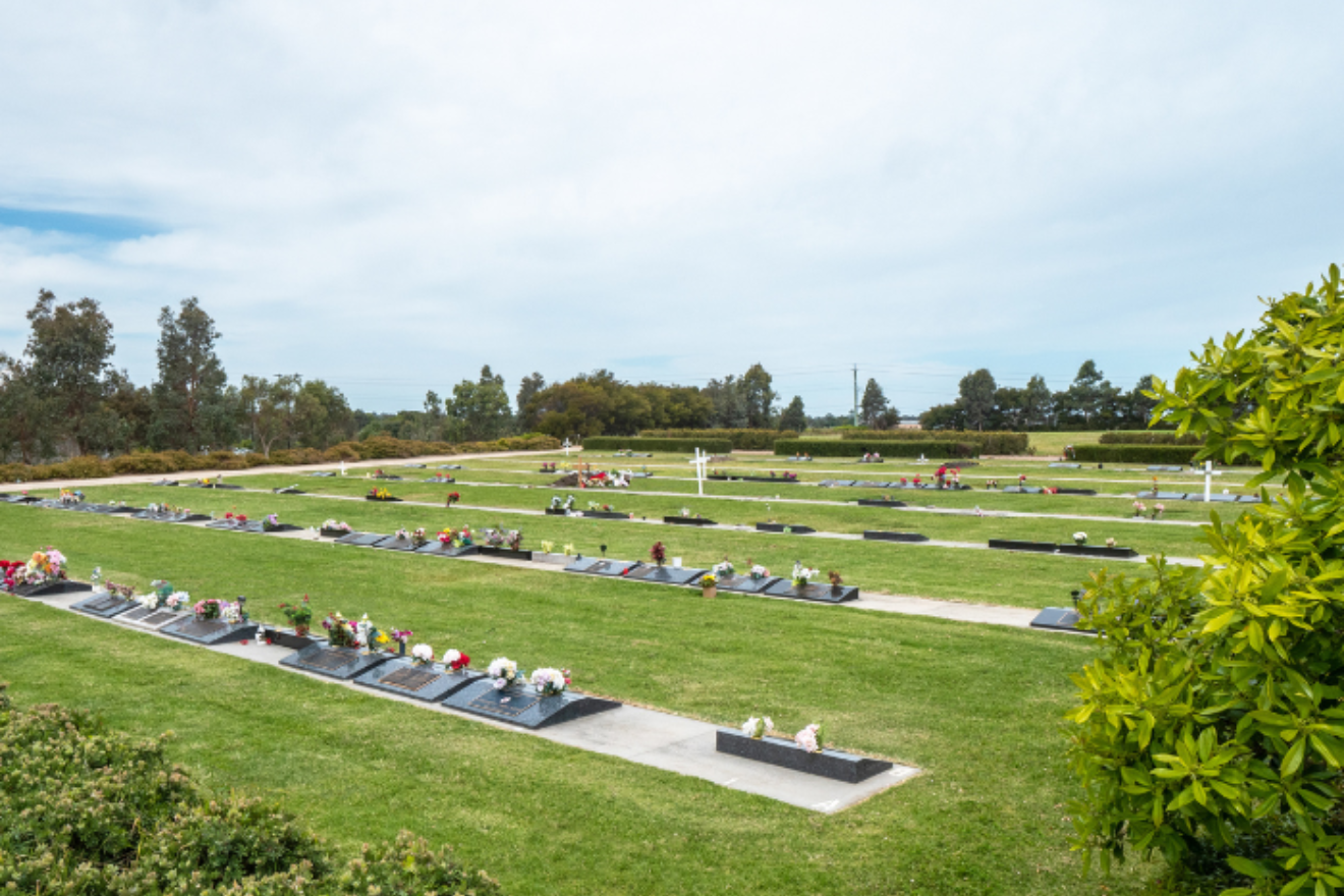 A view of a cemetery with lawn graves.