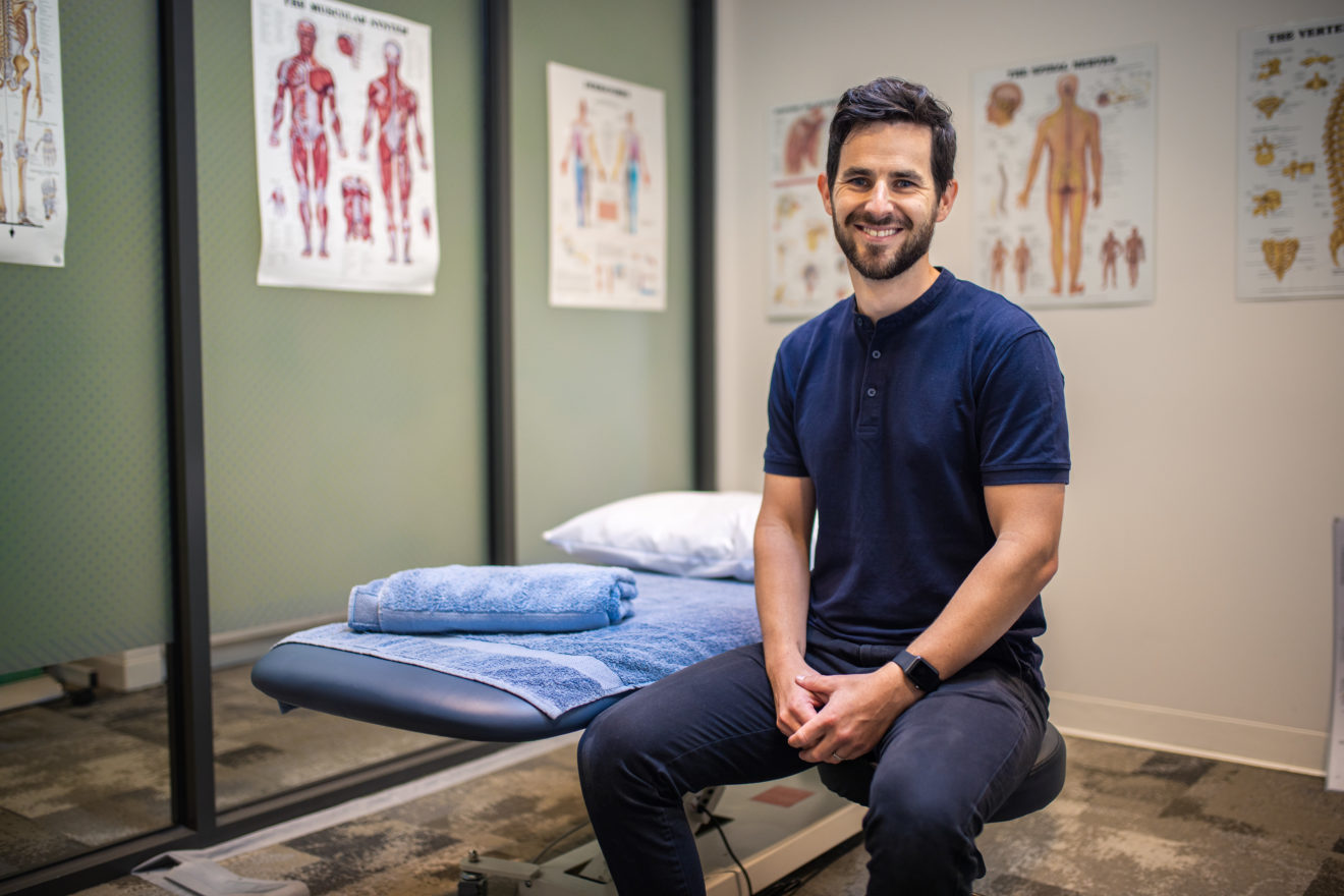 A photograph of SMCT osteopath Tom Peasley seated in the consultation room