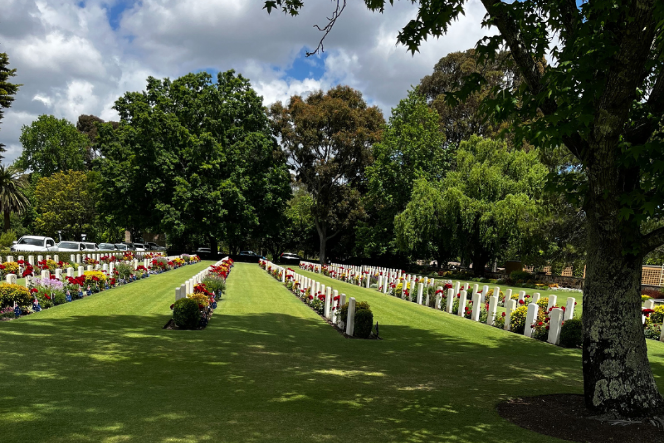 View out across the lawns towards rows of headstones at the Australian War Graves Garden of Remembrance.
