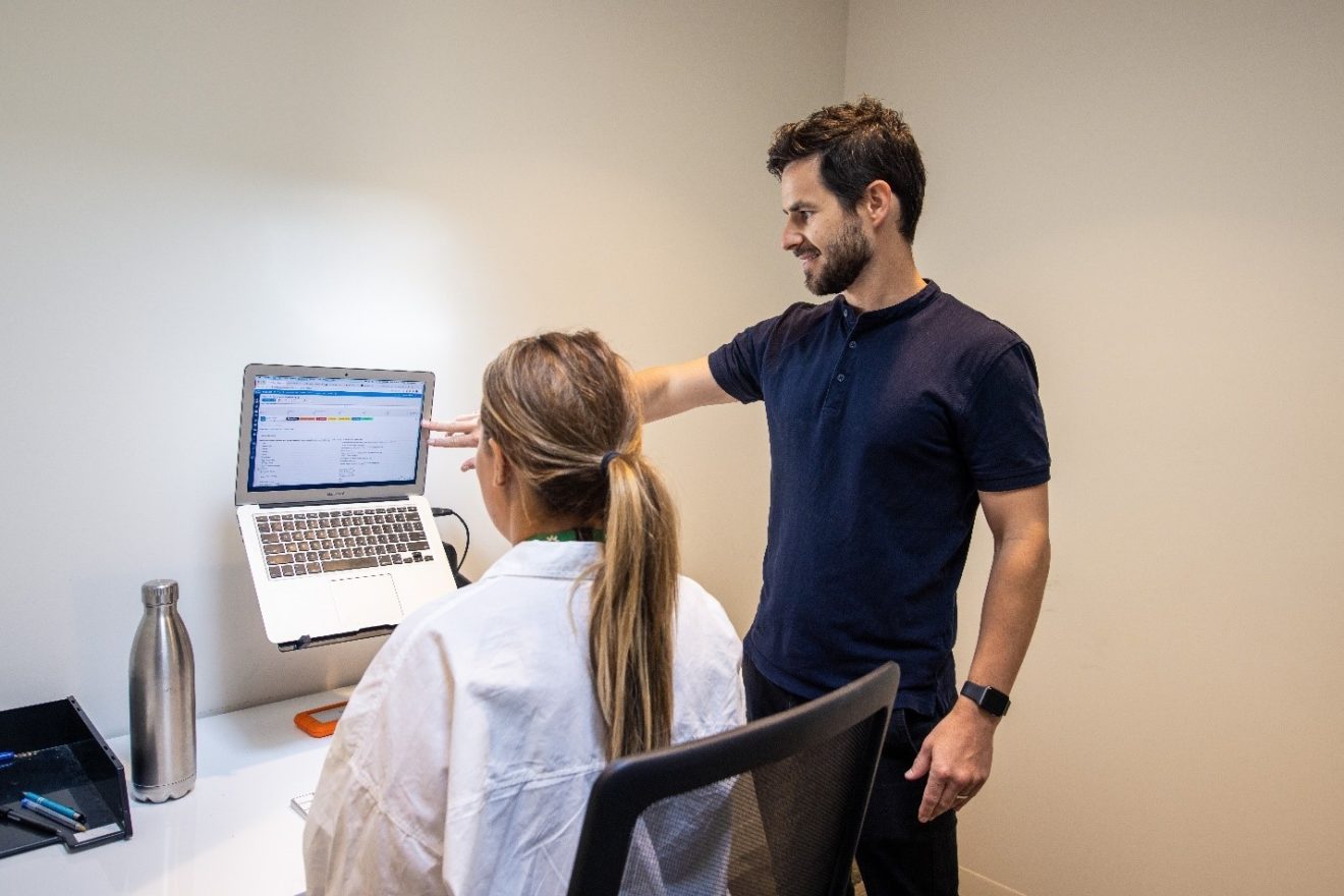 A photograph of SMCT Osteopath Tom Peasley providing a workspace assessment