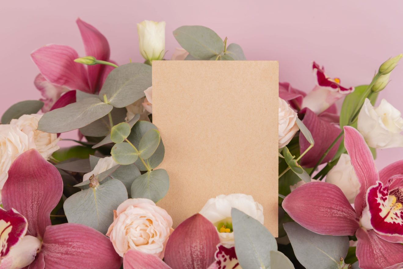 brown card amongst beautiful flowers