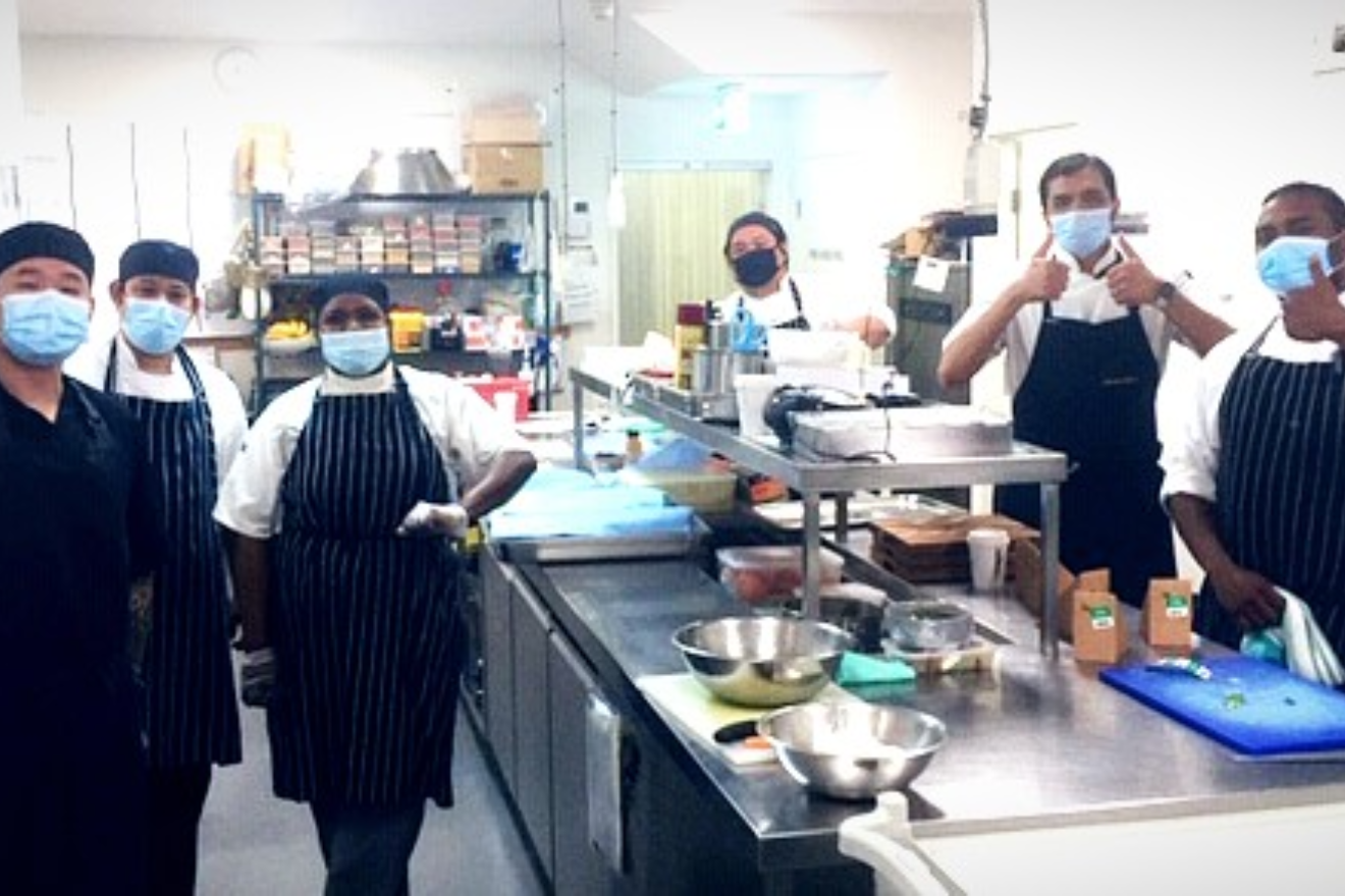 hospitality team giving thumbs up in the kitchen
