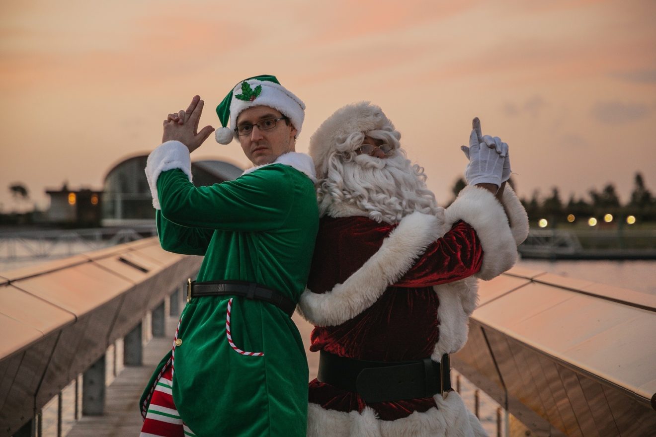 jake dressed as elf back to back with santa