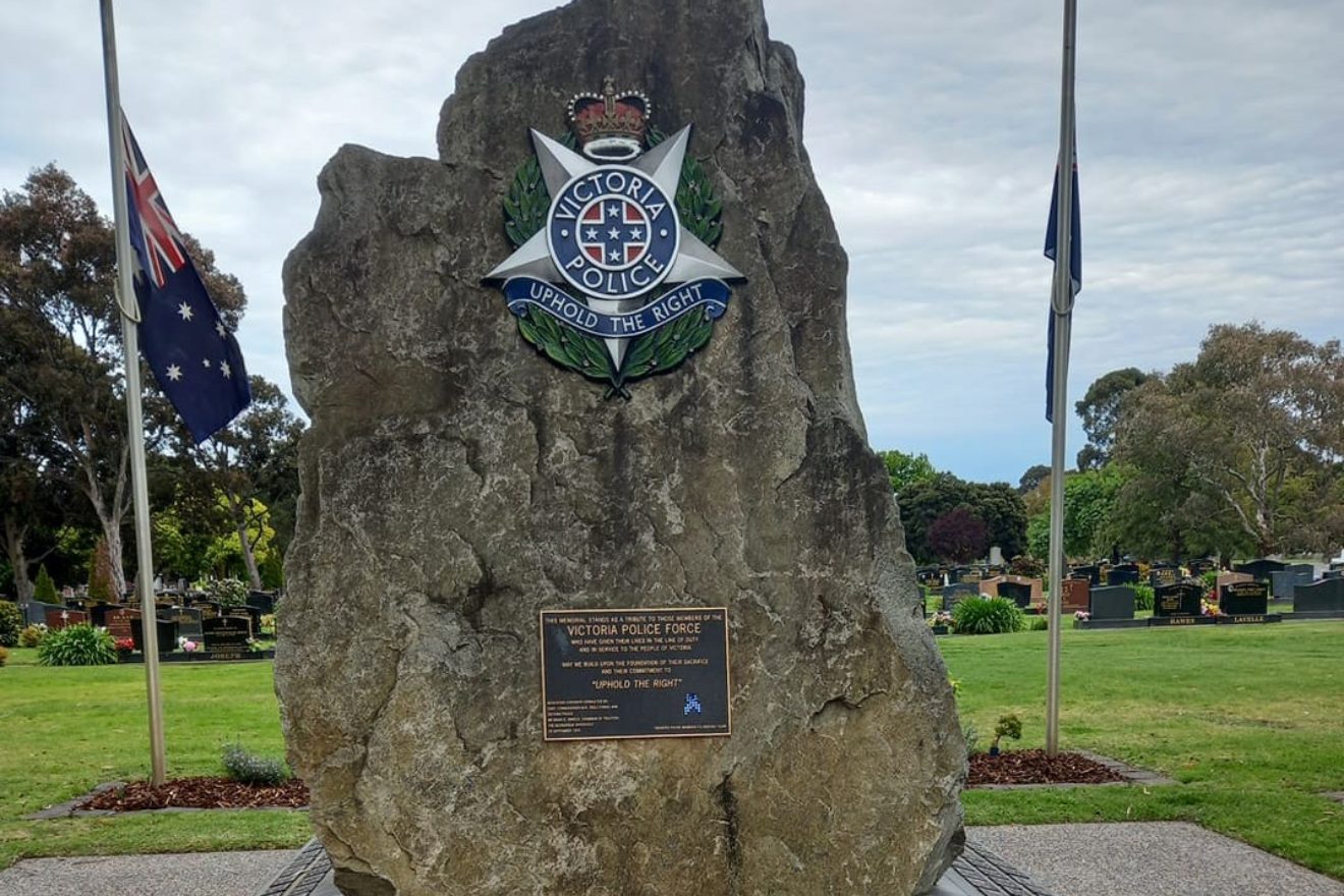 police memorial wreath blue ribbon lowered flag