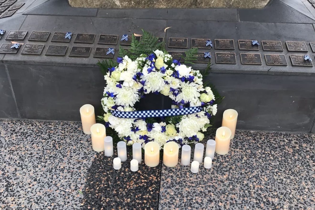 wreath laid at the police memorial surrounded by candles