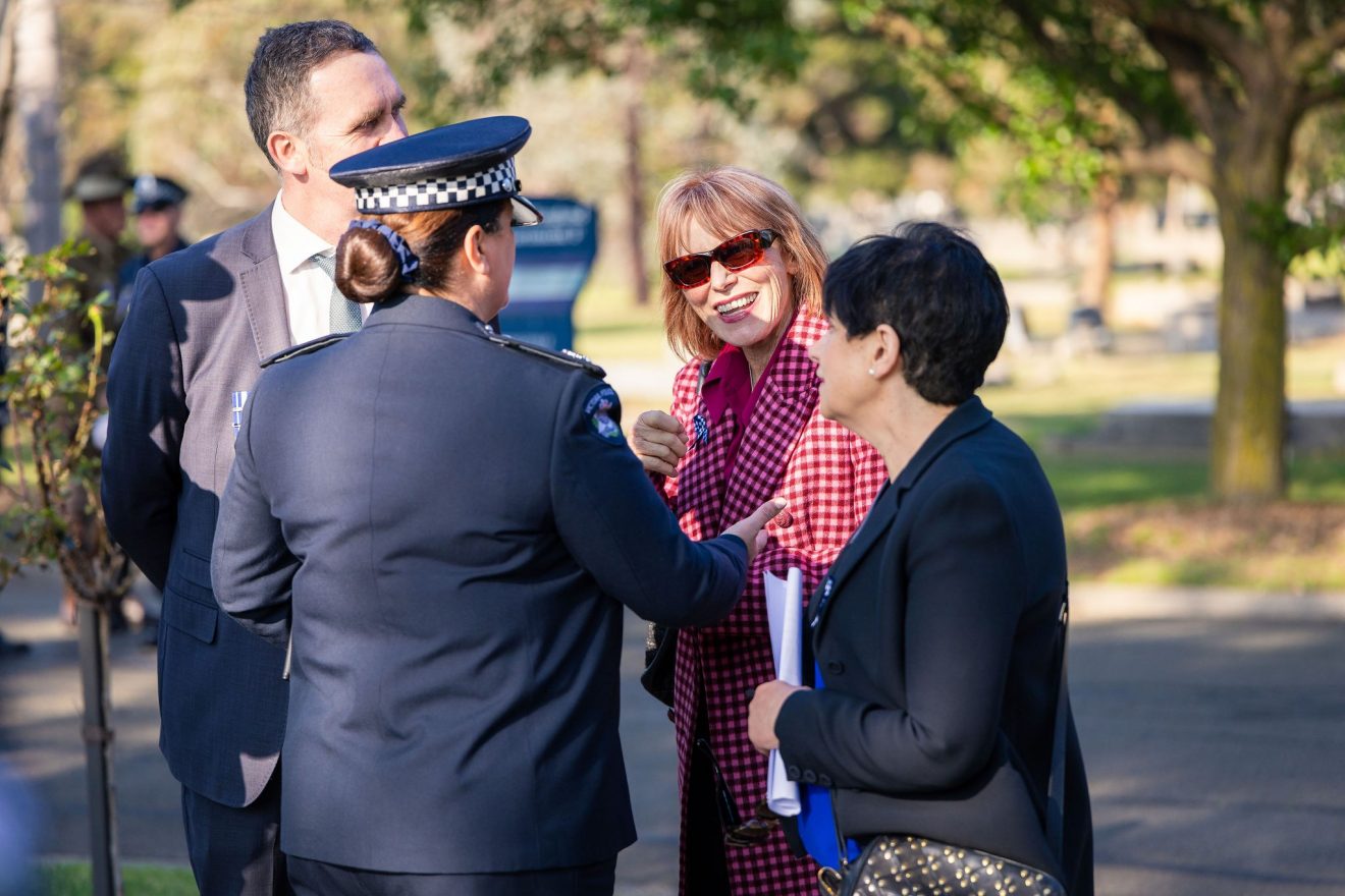 SMCT Interim CEO Lucinda Nolan speaking with a police officer in uniform.